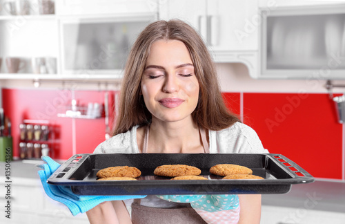 Young woman with cookies on...