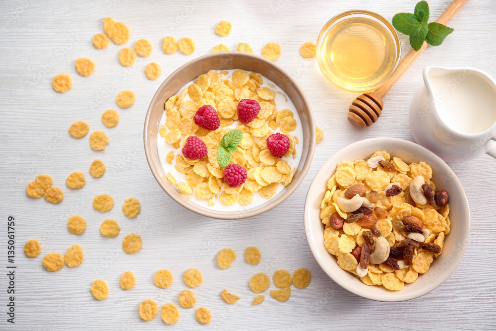 Tasty cornflakes with raspberries and honey on table Tasty cornflakes with raspberries and honey on table