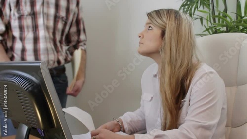 Boss berating female employee at corporate job photo