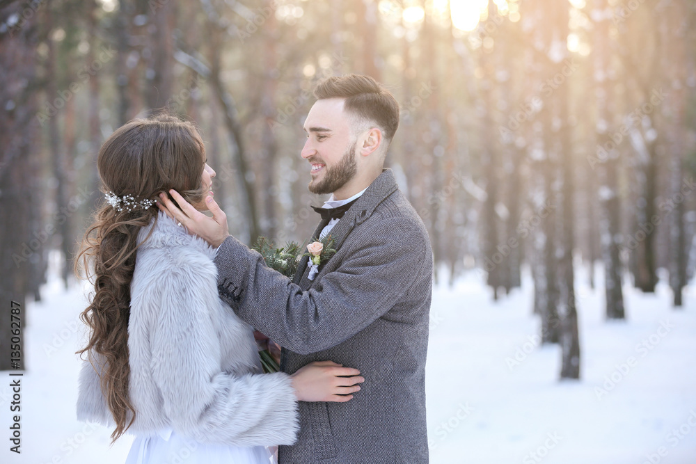 Happy wedding couple outdoors on winter day