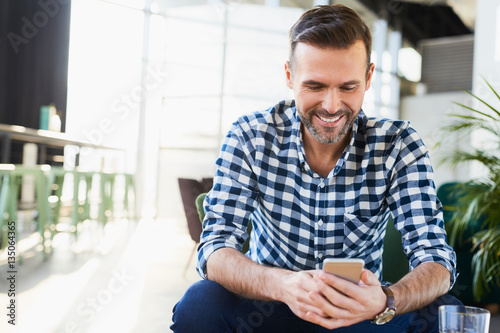Man smiling to smartphone