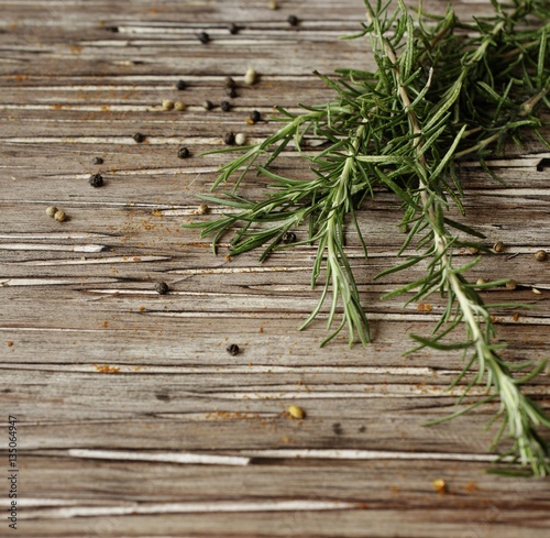 sprigs of rosemary with multi-colored pepper, selective focus