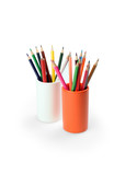 colorful pencils in an orange glass ceramic. on a white background