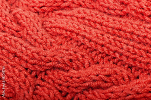 Background of red knitted fabric. © TADDEUS