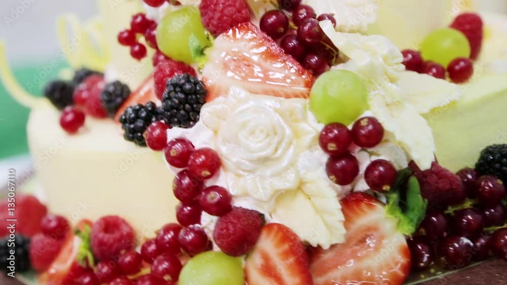 Cake decorated with red currant berries, grapes, strawberries, blackberries, raspberries and cream. Cake decorated with red currant berries, grapes, strawberries, blackberries, raspberries and cream.