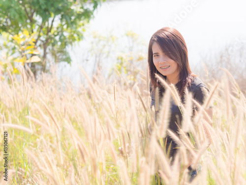 Asian beautiful Woman in the Meadow. On a sunny days.