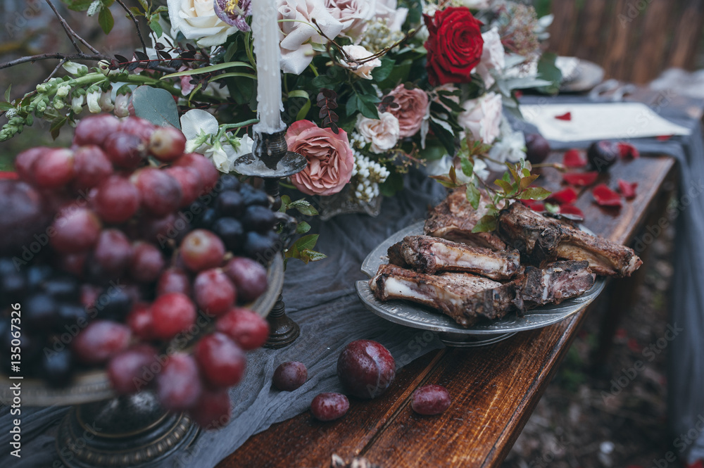 Wedding table with meat and flowers in nature. decoration Wedding table with meat and flowers in nature. decoration