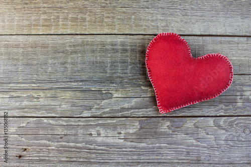 Fluffy red heart hand made on an old wooden  background
