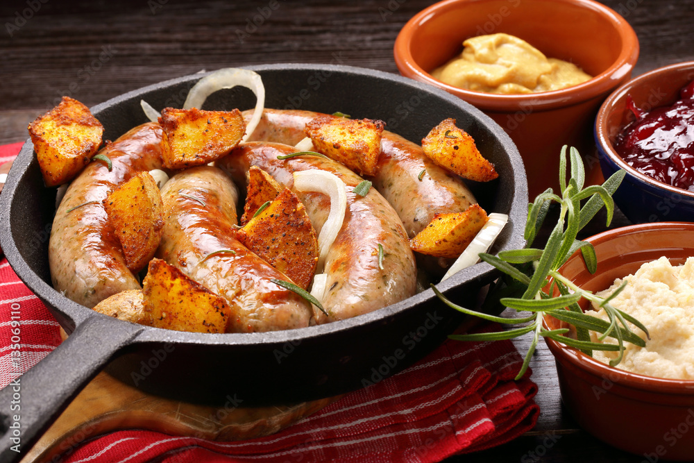 Roast sausage with rosemary garlic and baked potatoes Roast sausage with rosemary garlic and baked potatoes