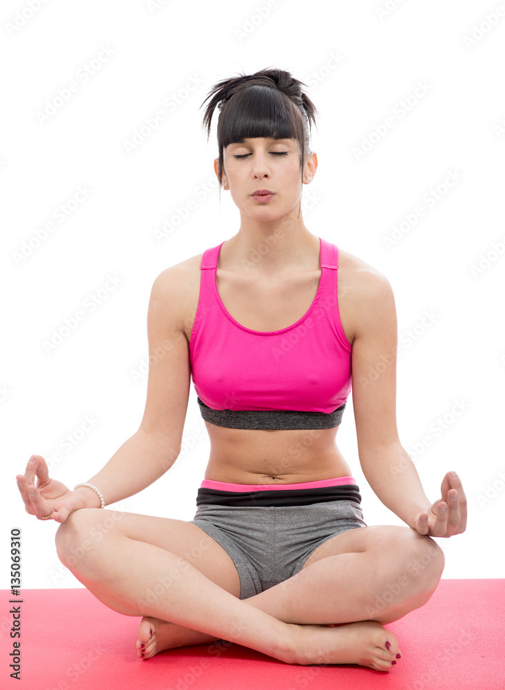 sportygirl in pink sportswear practicing yoga lotus pose