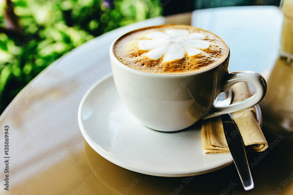 Hot cup of coffee on the table, latte art