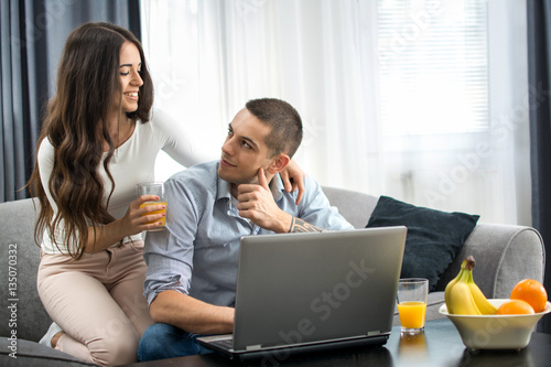 Young couple with laptop at home. © Bojan