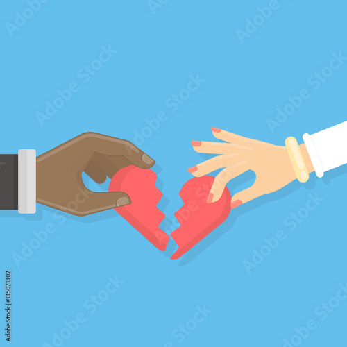 Broken heart concept. Male and female hands hold pieces of broken heart. Idea of divorce and break up. African american.