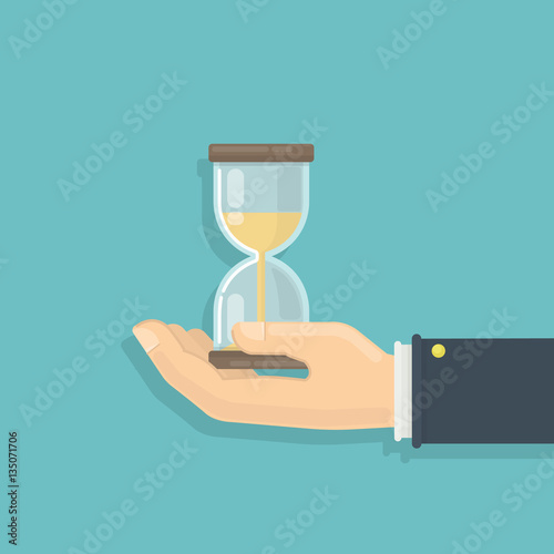 Male hand with hourglass. Concept of patience, deadline and limit.