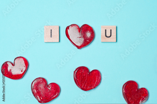 Lollipops with wooden letters. Red hearts. Candy. Love concept. Valentine day. photo