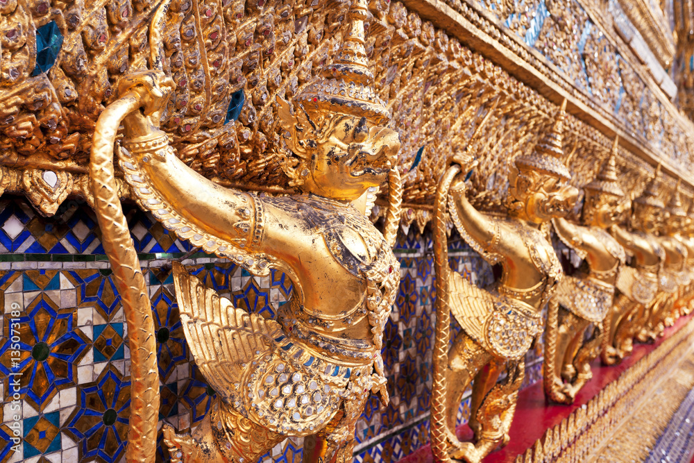 Ubosoth Golden Demon decorations on the side of the Wat Phra Kaew in Bangkok, Thailand 