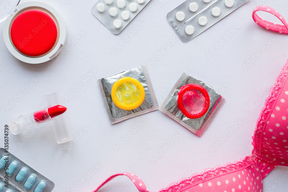Women's Accessories, condoms and birth control pills on a white background Women's Accessories, condoms and birth control pills on a white background