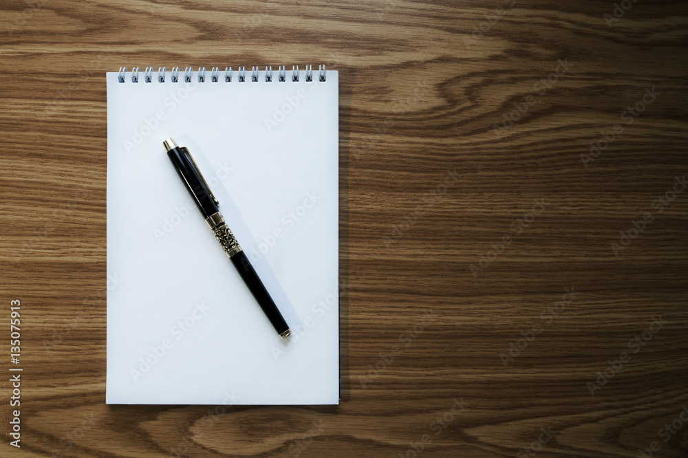 Notebook and fountain pen on wooden background Notebook and fountain pen on wooden background