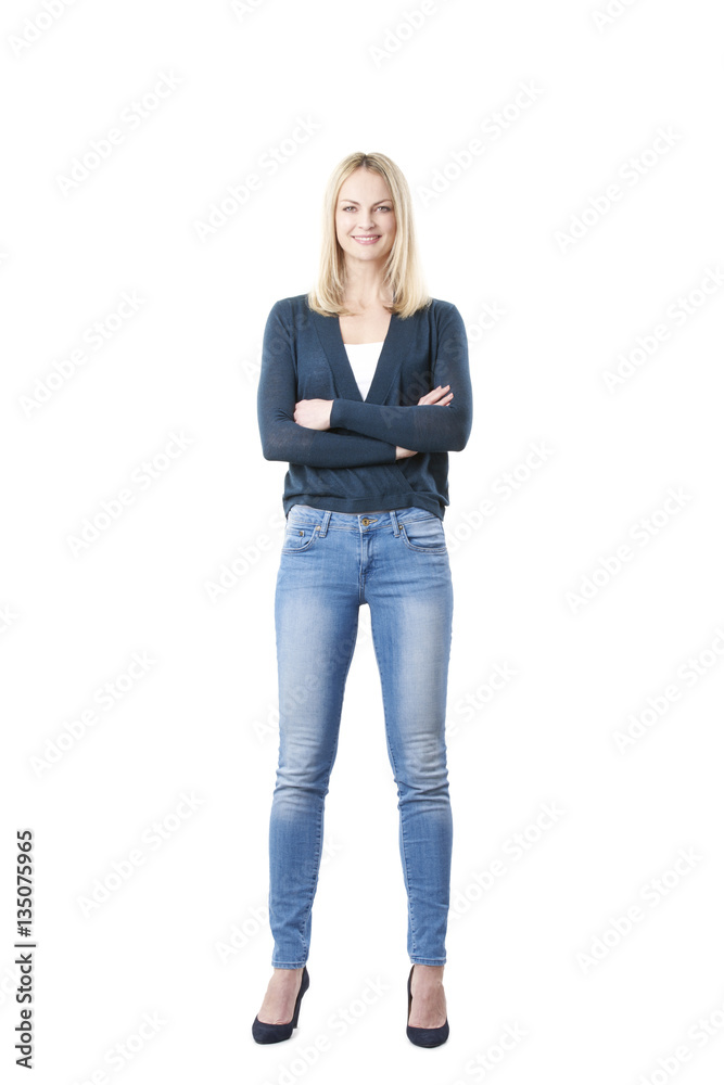 Confident mature female portrait. Full length shot of a smiling middle aged  woman wearing casual clothing while standing at isolated white background.  Stock Photo