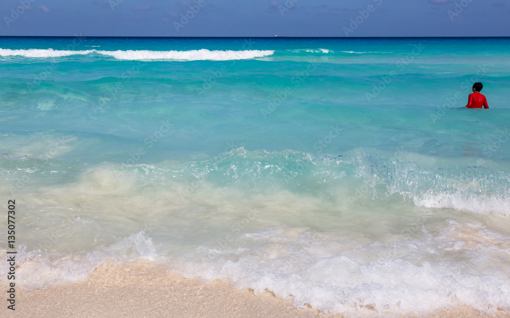 Obraz premium CANCUN, MEXICO - JULE 30, 2013: On a sunny beach in Cancun Mexico. Summer vacation on the Caribbean coast.