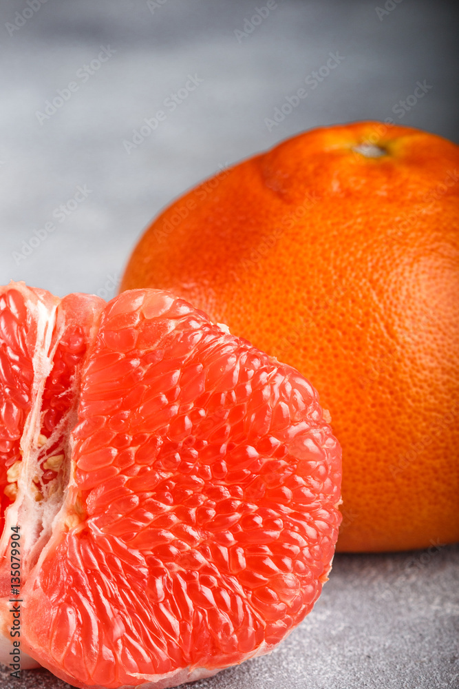 Juicy grapefruit close up on the gray stone table
Juicy grapefruit close up on the gray stone table