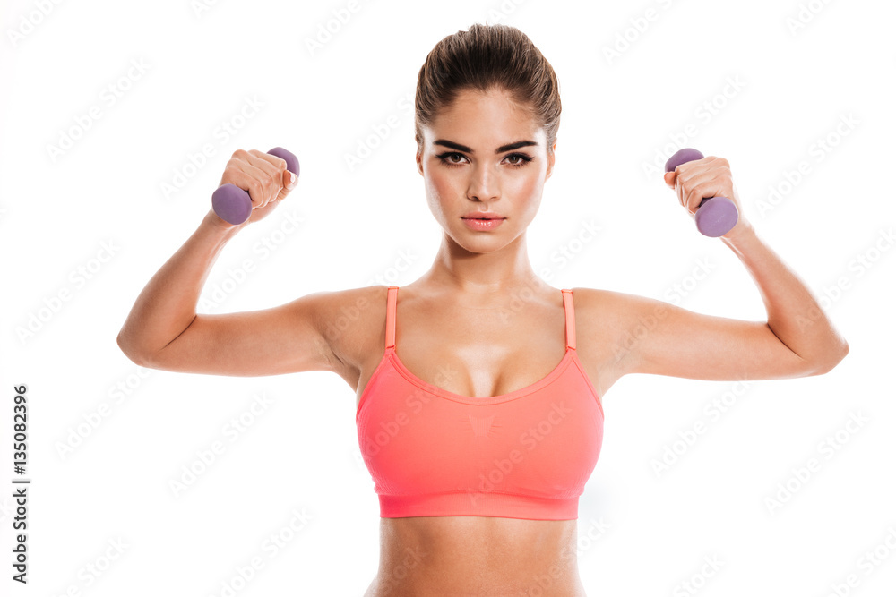 Portrait of a young woman working out with dumbbells Portrait of a young woman working out with dumbbells
