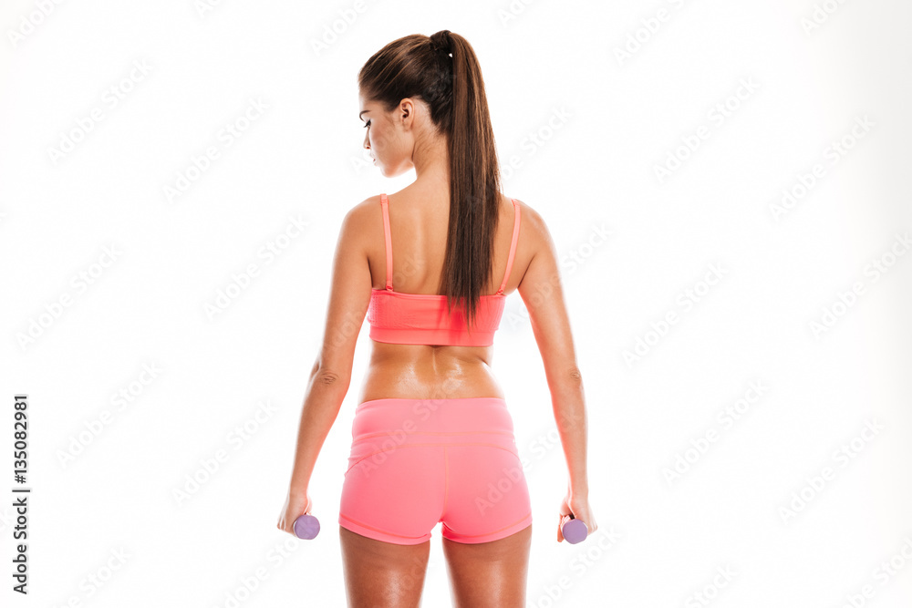 Portrait of a young healthy fitness woman holding dumbbells Portrait of a young healthy fitness woman holding dumbbells
