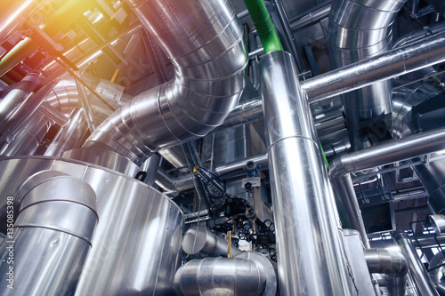 Equipment, cables and piping as found inside of a modern industr
