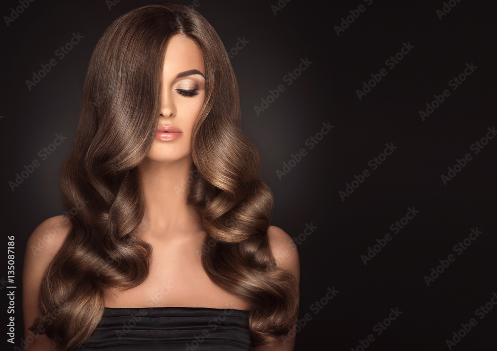 Brunette girl with long and shiny wavy hair . Beautiful model with curly  hairstyle . Stock Photo | Adobe Stock