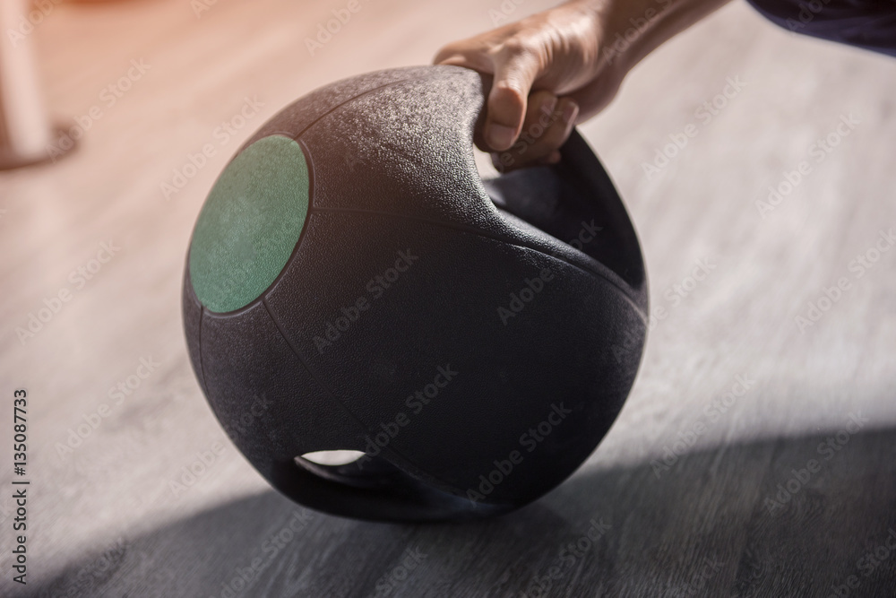 Fototapeta premium close up of man holding weight in gym