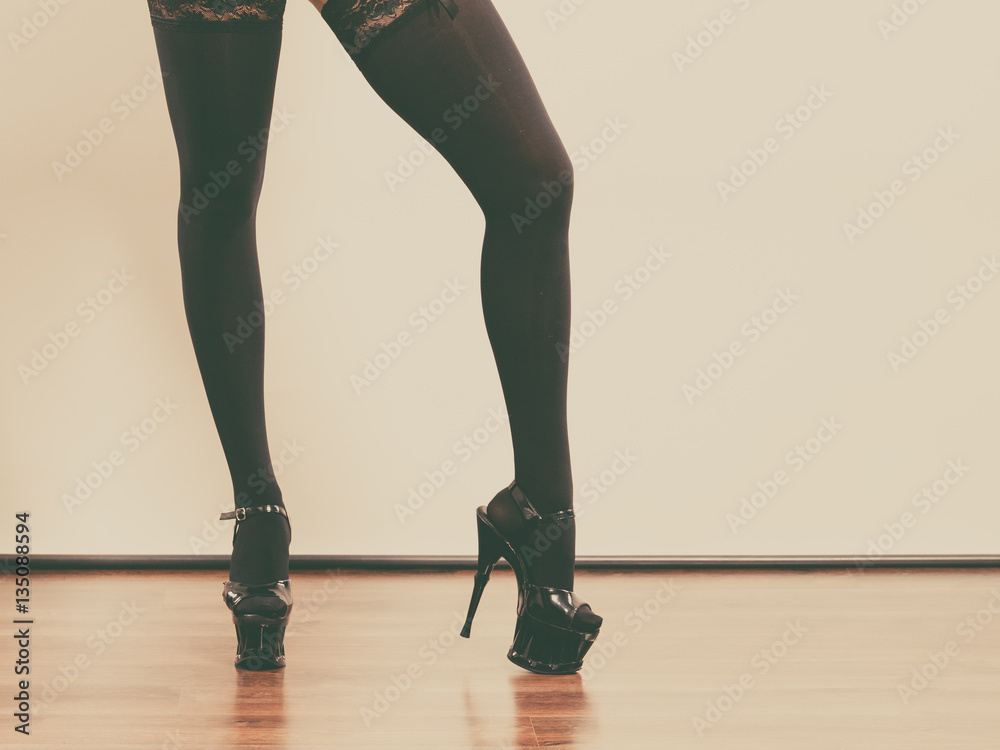 Sexy long female legs in black. Sexy long female legs in black.