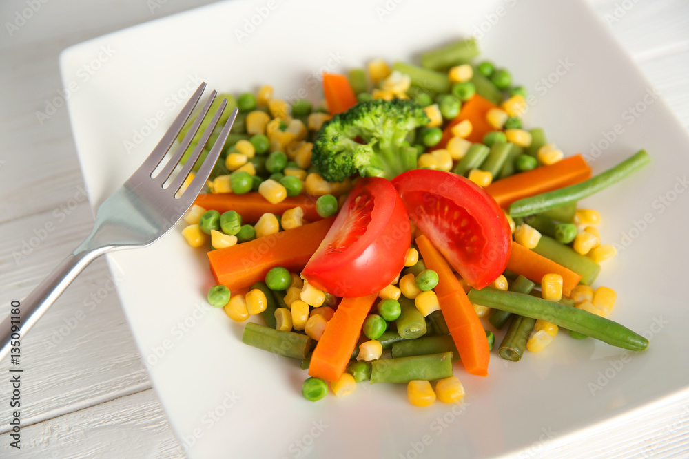 Plate with fresh vegetables, close up