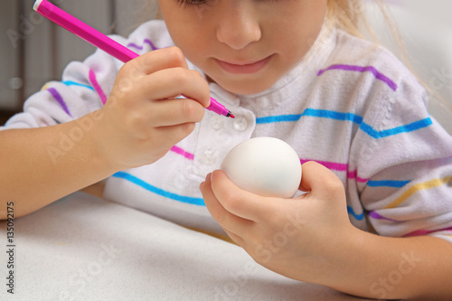 Cute little girl painting e...