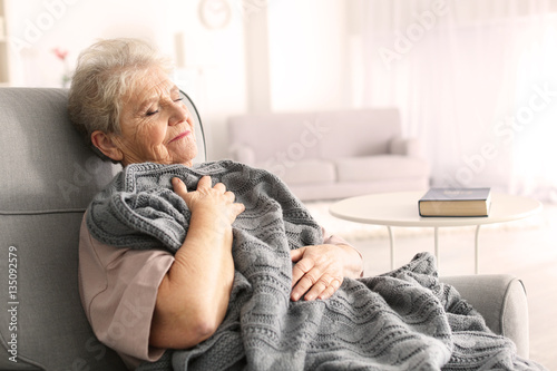 Depressed elderly woman sit...