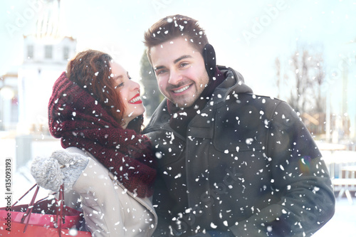 Young couple in snowfall ou...