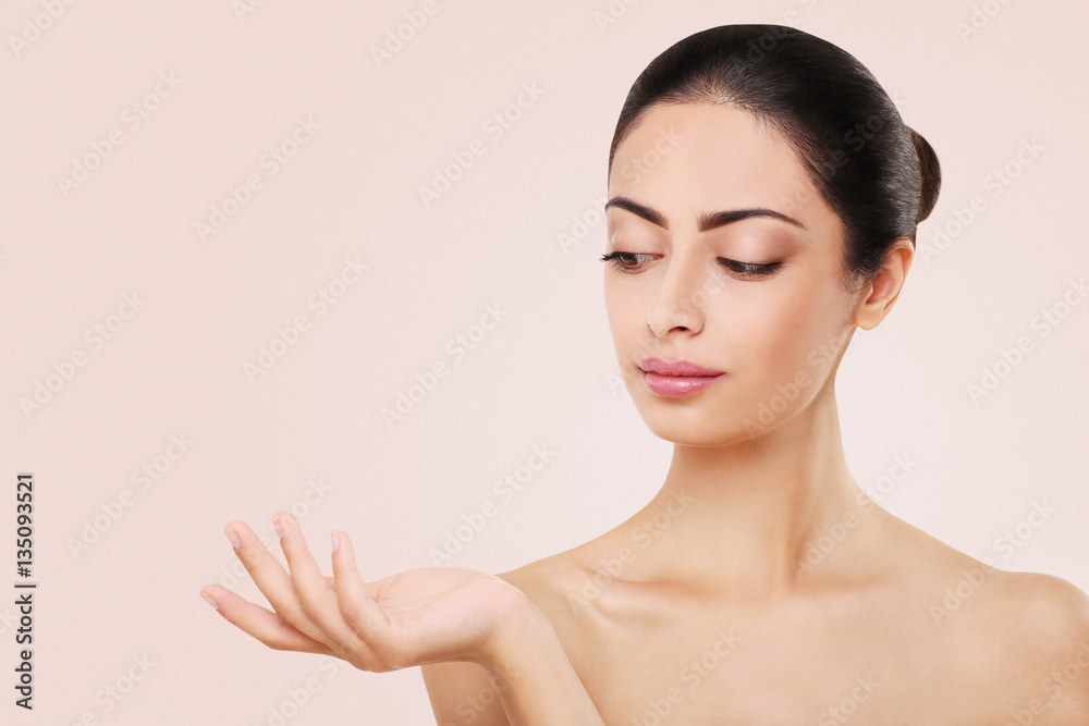 Beautiful indian girl with perfect skin, isolated on pink background Beautiful indian girl with perfect skin, isolated on pink background