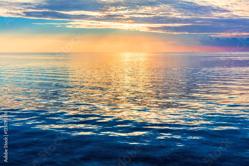 Tablou canvas Calm ocean at sunset. Dramatic sky