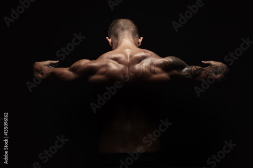 Unrecognizable man shows strong neck muscles closeup © Prostock-studio
