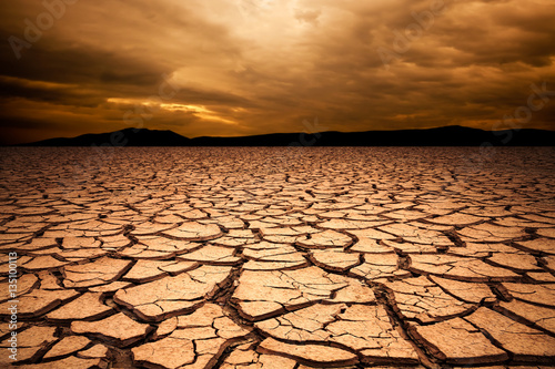 Fotografia, Obraz dramatic sunset over cracked earth. Desert landscape background.