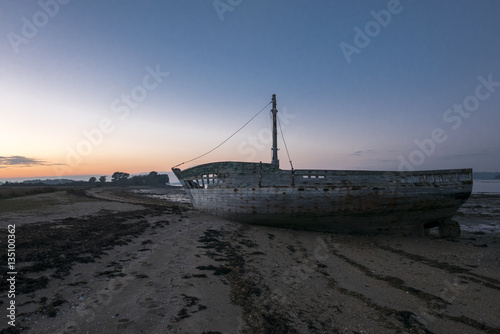 Sunset and old shipwreck in Arz Island in Brittany (Morbihan), F