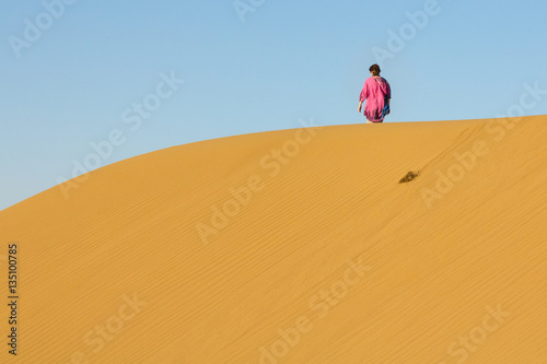 Woman walking on Sand dunes in the Maranjab desert  near Kashan  Iran