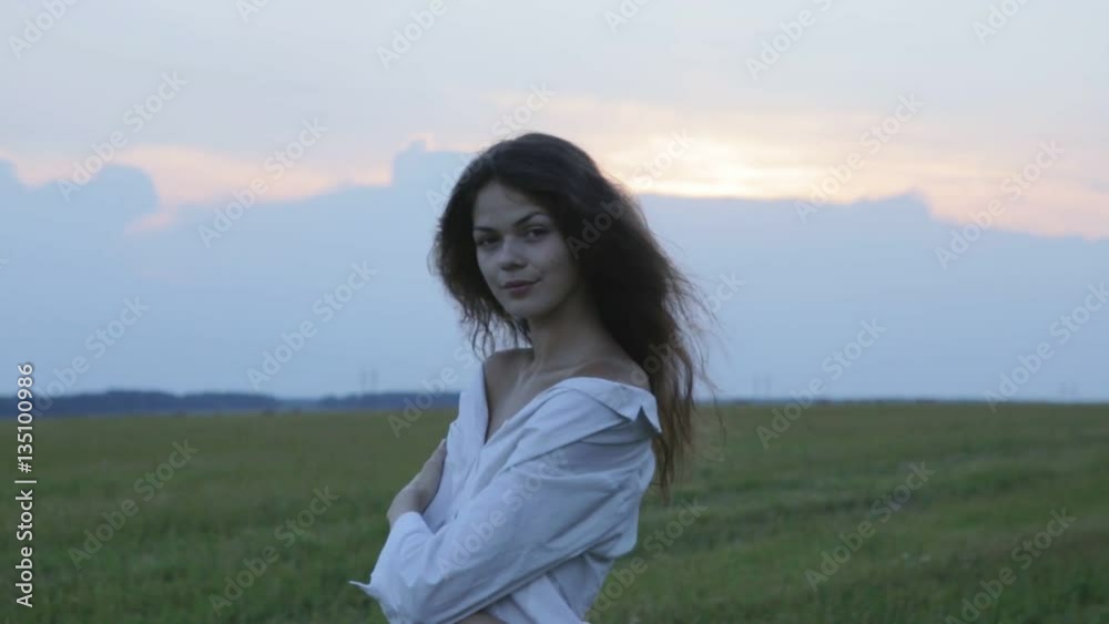 Young pretty woman looking on dusk Young pretty woman looking on dusk