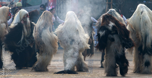 PERNIK, BULGARIA - JANUARY 29, 2017 - Masquerade festival Surva in Pernik, Bulgaria. People with mask called Kukeri dance and perform to scare the evil spirits photo