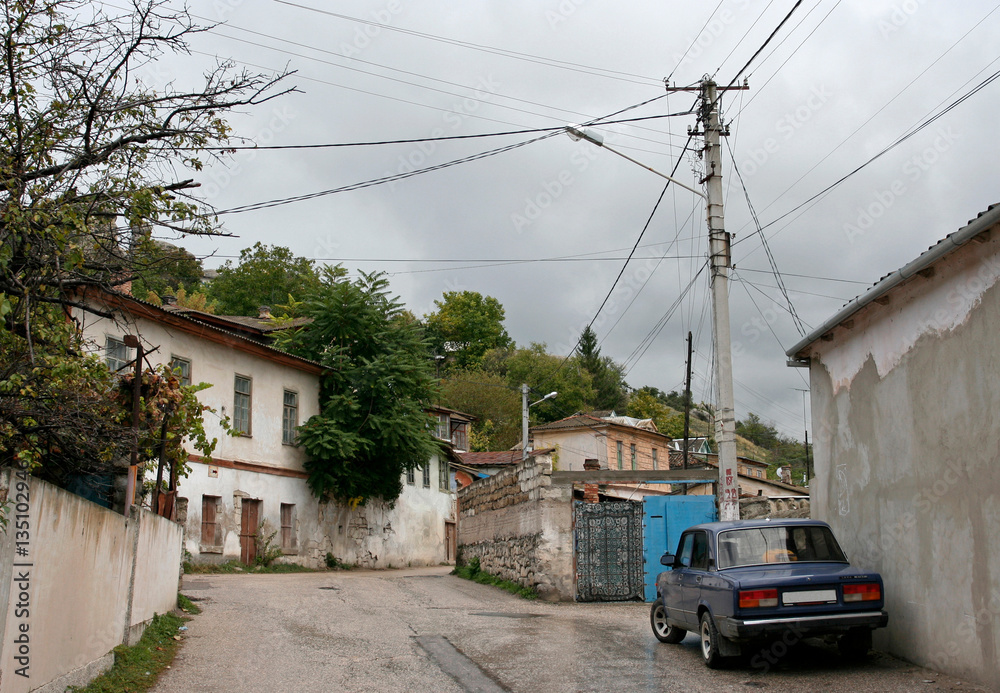 The car on the unfrequented street of the Old Town of Bakhchisarai, Crimea