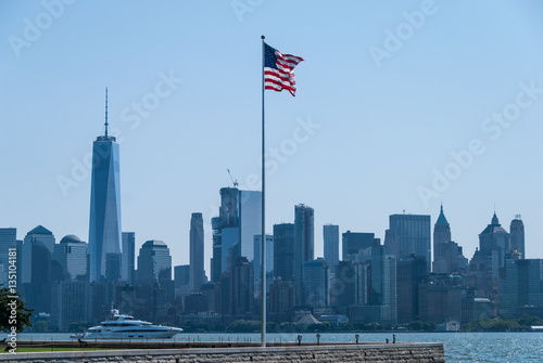 American flag with New York downtown in the background