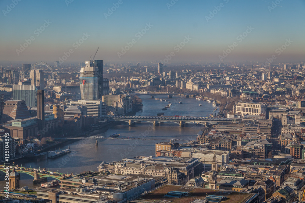 a view of river Thames in London on a sunny day with visible smog, air pollution