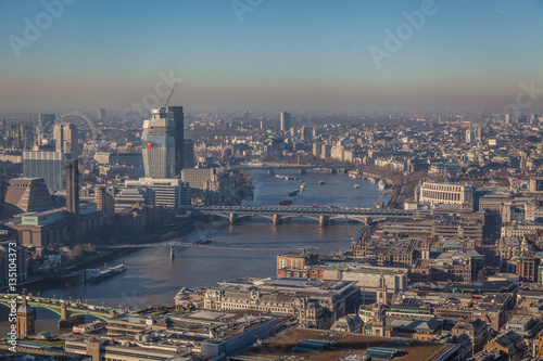 a view of river Thames in London on a sunny day with visible smog, air pollution © osnuya