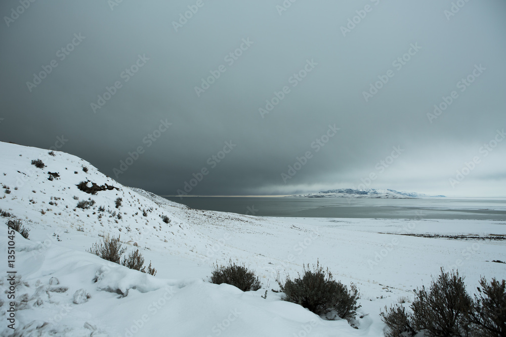 Shoreline  and mountains of Antelope Island at winter  during blizzard in the Great Salt Lake, Utah