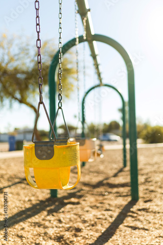 Yellow infants swing at public playground