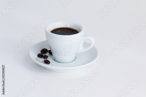 Cup of espresso coffee and coffee beans on white desk © Studio Dagdagaz